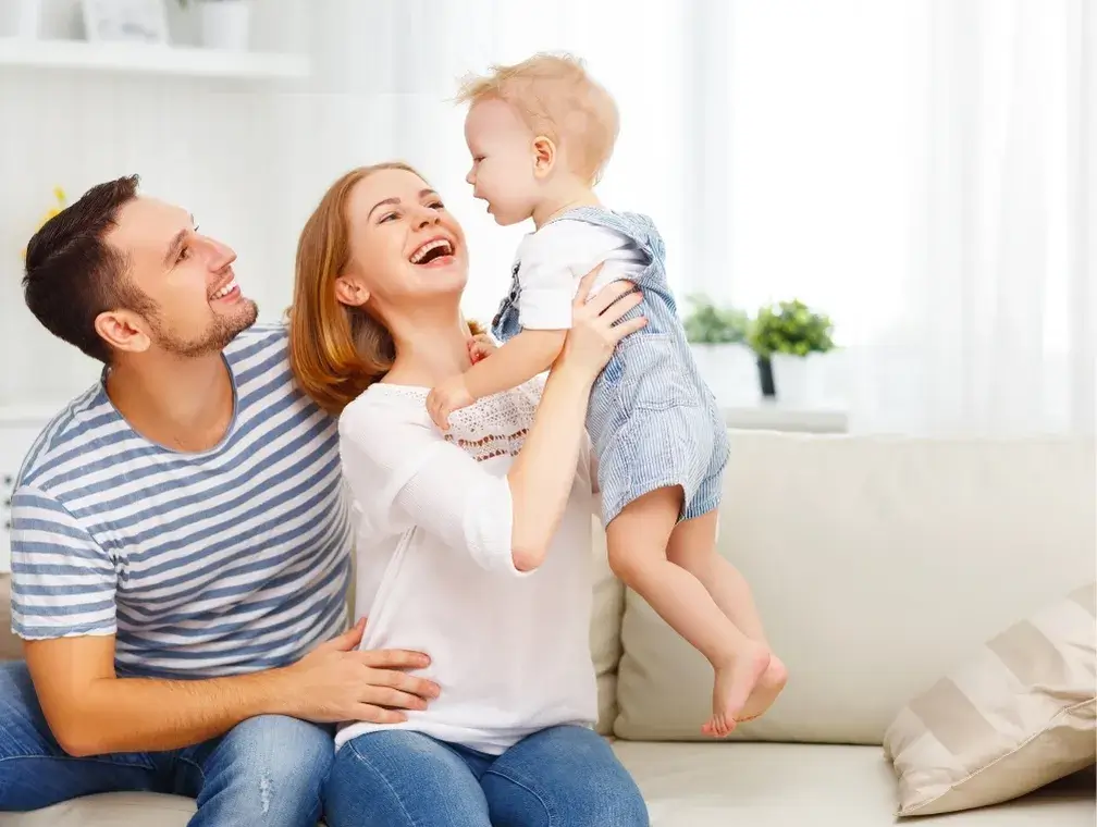 Happy family enjoying the emotional relief of a clean home provided by professional maid services